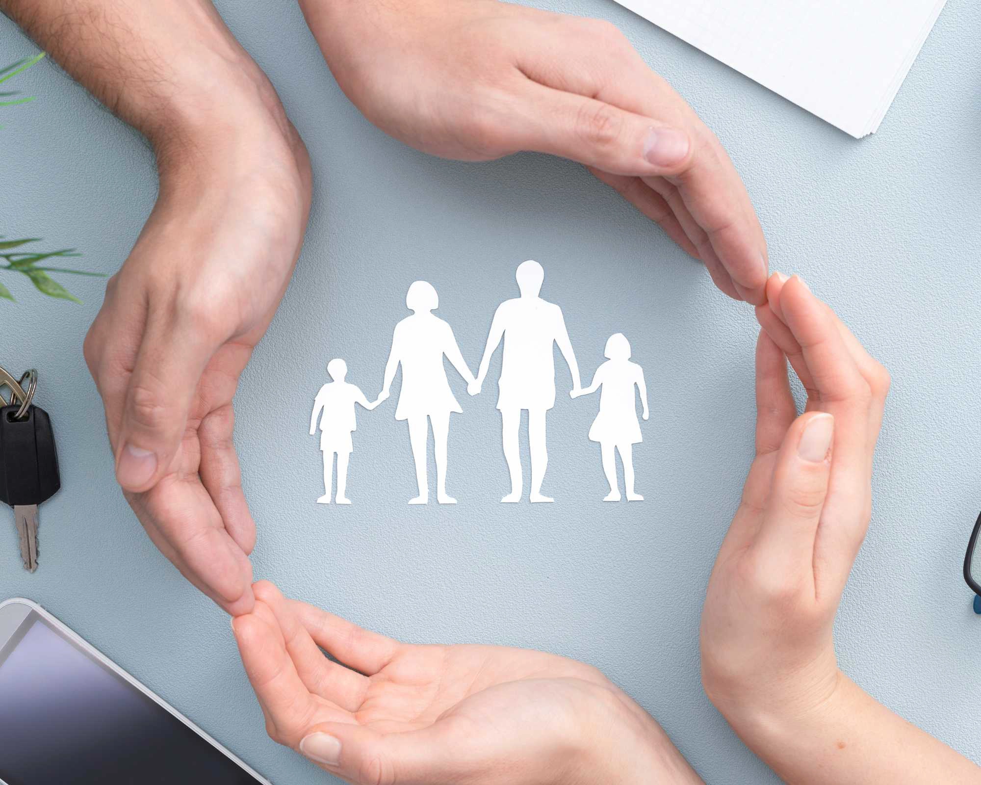 Social Care image showing a family with hands around them